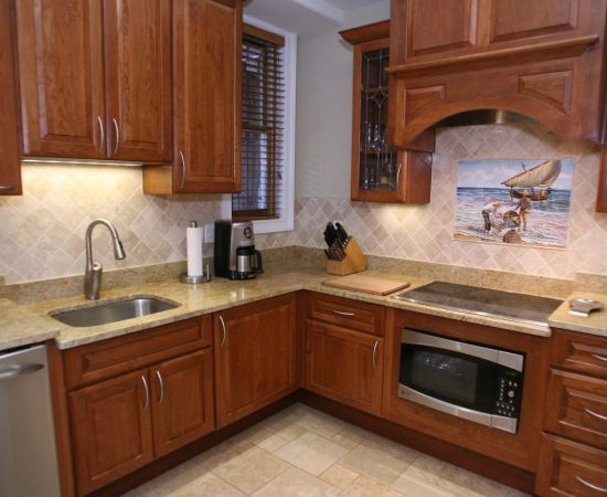 an accessible kitchen with wooden cabinets and stainless steel appliances