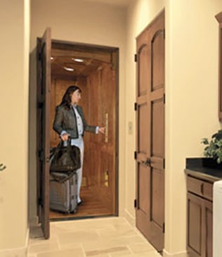 a woman with a suitcase is entering the bathroom