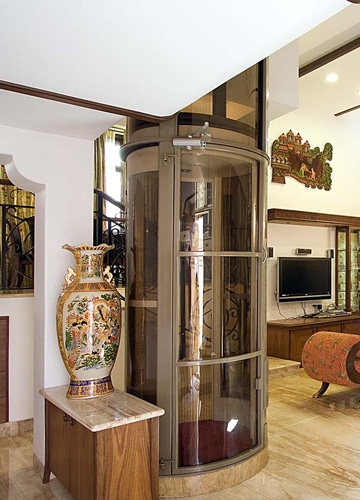 a living room with a large glass pneumatic vacuum elevator