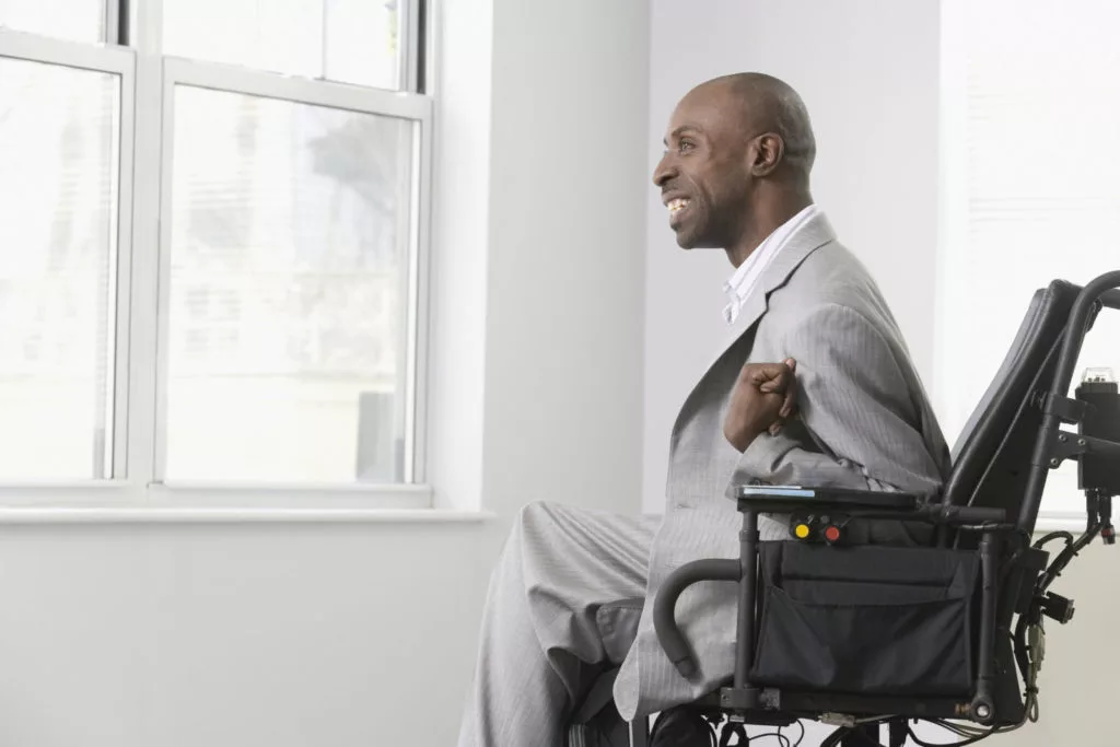 a man in a suit sitting in a wheelchair