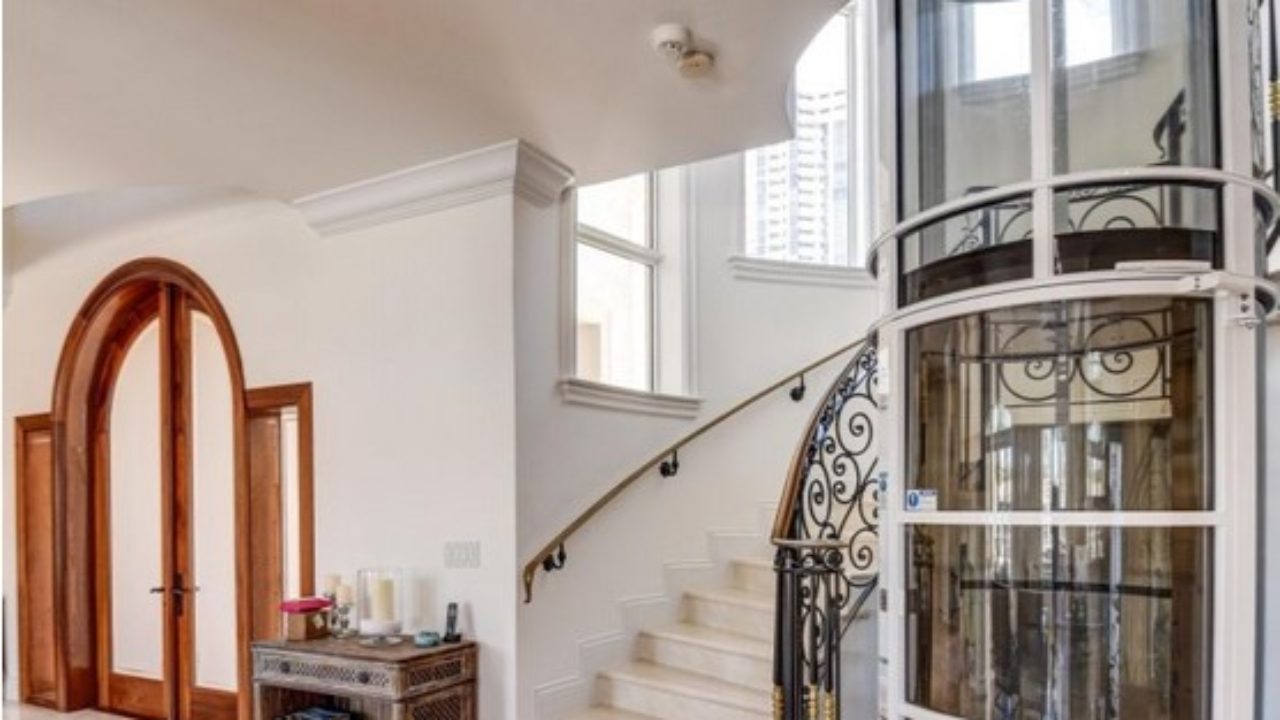a staircase leading to a second story with a home elevator