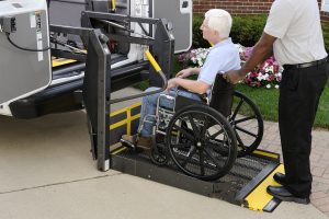 a man in a wheel chair being pushed by another man