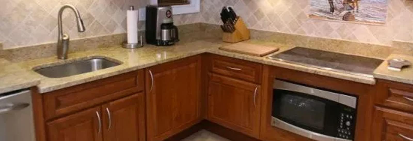 a kitchen with wooden cabinets and stainless steel appliances